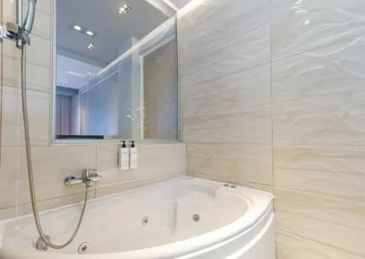 A bright and elegant room at Alpha Luxury Suites, featuring high-quality bedding, modern decor, and a private balcony overlooking the Aegean Sea. Perfect for a romantic getaway in Pefkohori.
