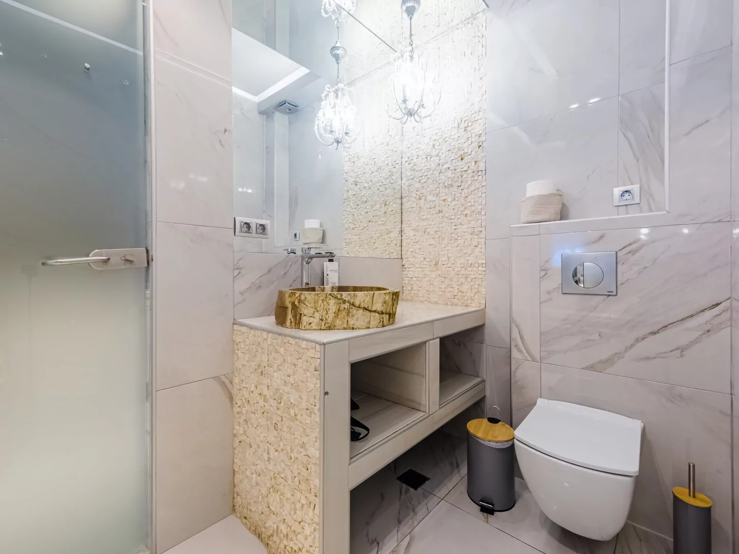 Modern marble bathroom with walk-in rain shower and luxury amenities at Alpha Luxury Suites
