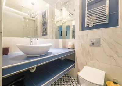 Spacious and clean bathroom design with marble finishes, high-tech fixtures, and premium toiletries for a spa-like experience.