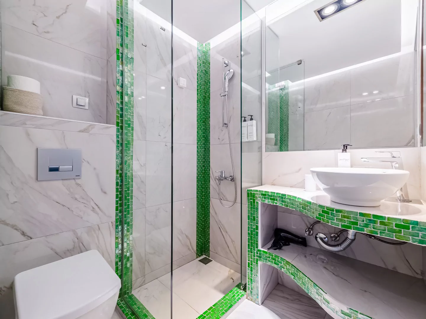 Modern marble bathroom with walk-in rain shower and luxury amenities at Alpha Luxury Suites