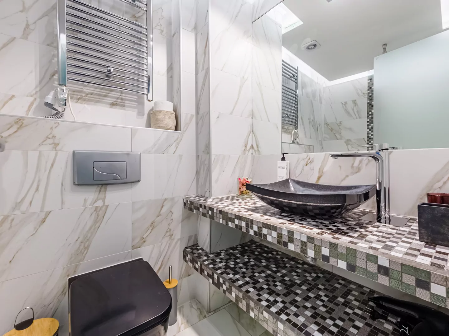 Modern marble bathroom with walk-in rain shower and luxury amenities at Alpha Luxury Suites