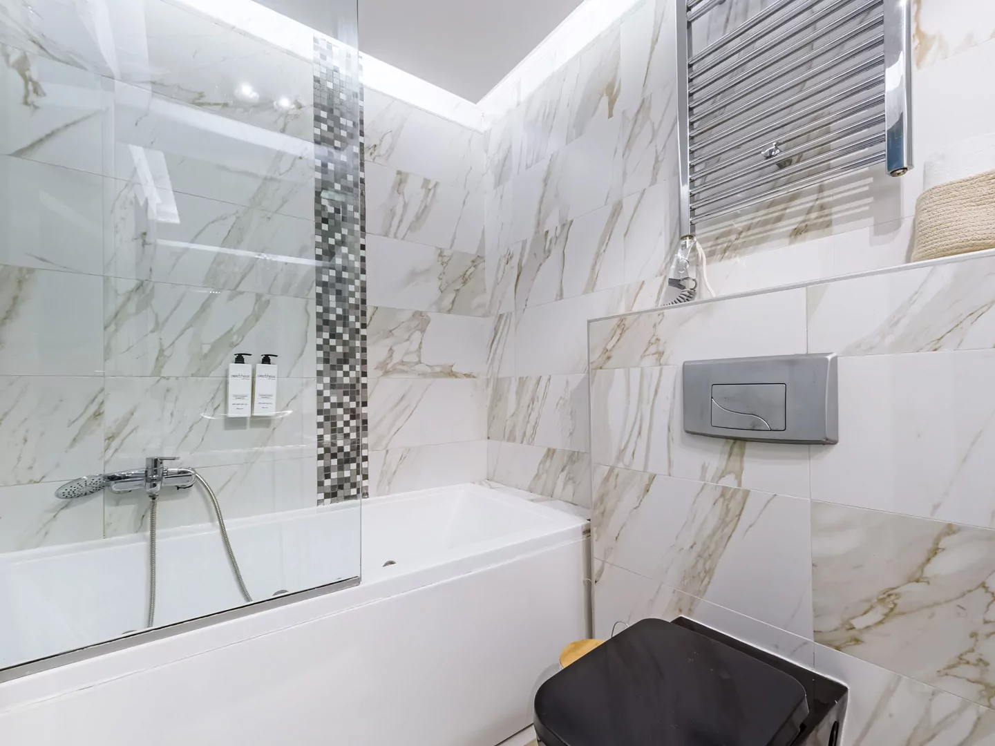 Modern marble bathroom with walk-in rain shower and luxury amenities at Alpha Luxury Suites