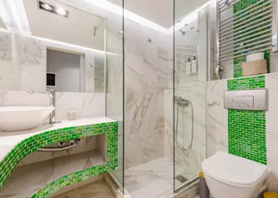 Modern marble bathroom with walk-in rain shower and luxury amenities at Alpha Luxury Suites