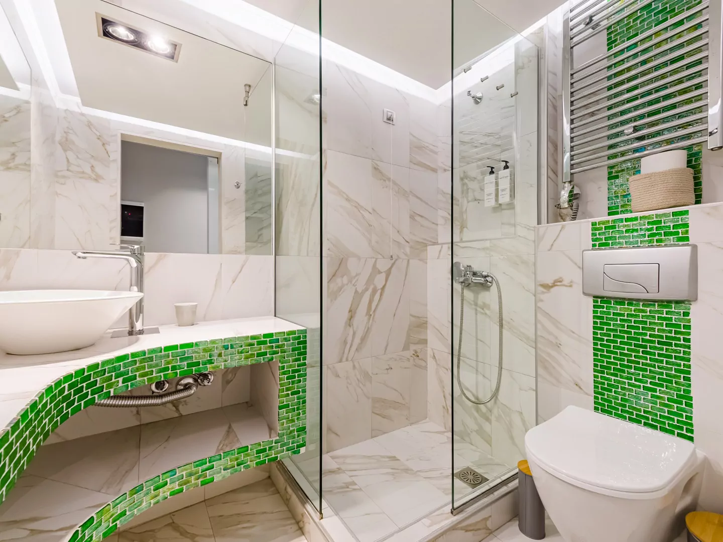 Modern marble bathroom with walk-in rain shower and luxury amenities at Alpha Luxury Suites