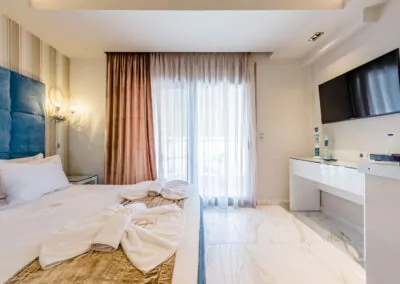 Modern luxury suite bedroom with sea view balcony at Alpha Luxury Suites Pefkohori Halkidiki