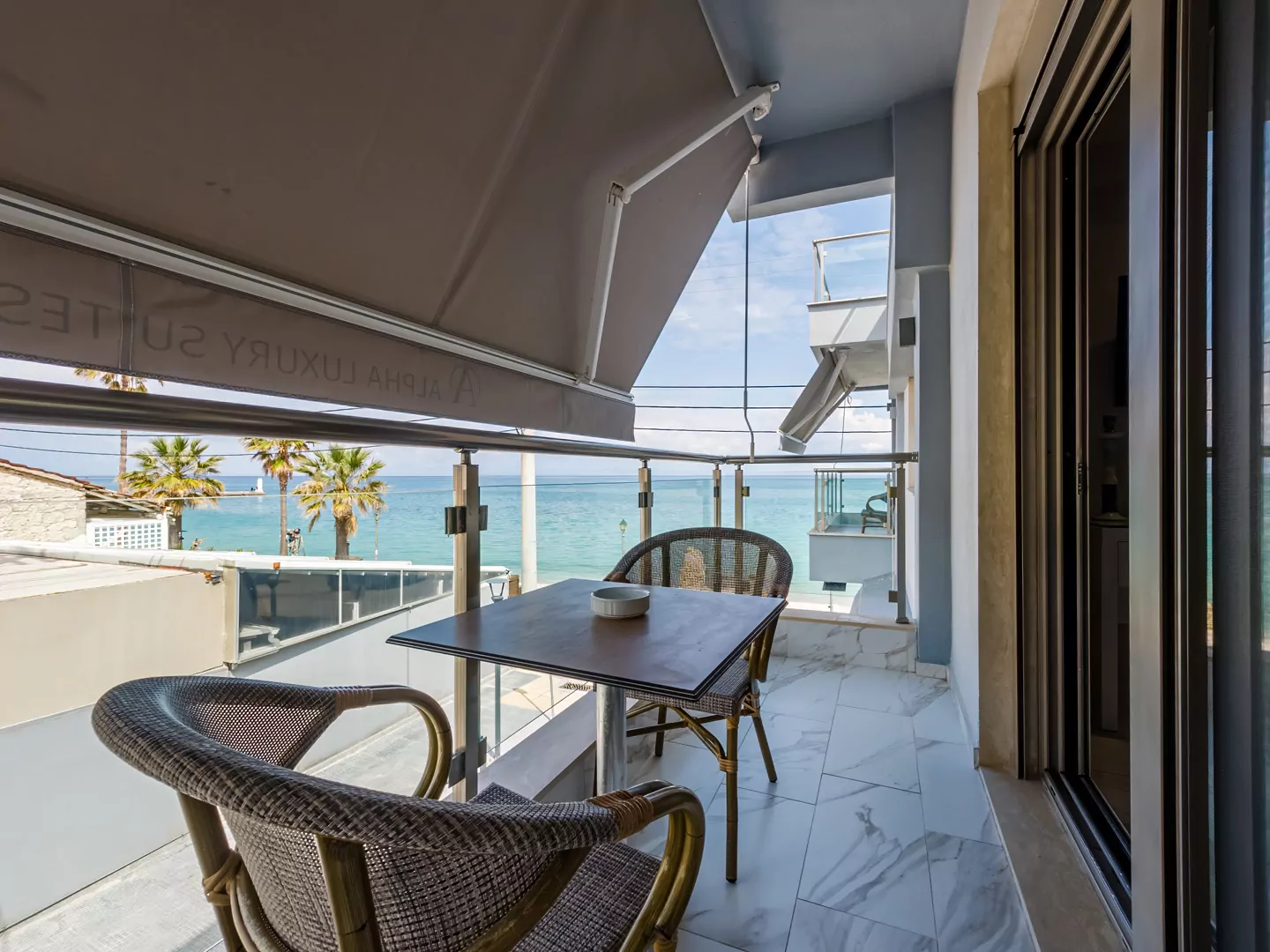 Sunset view from Alpha Luxury Suites Rooftop Bar in Pefkohori with sea view and cocktails