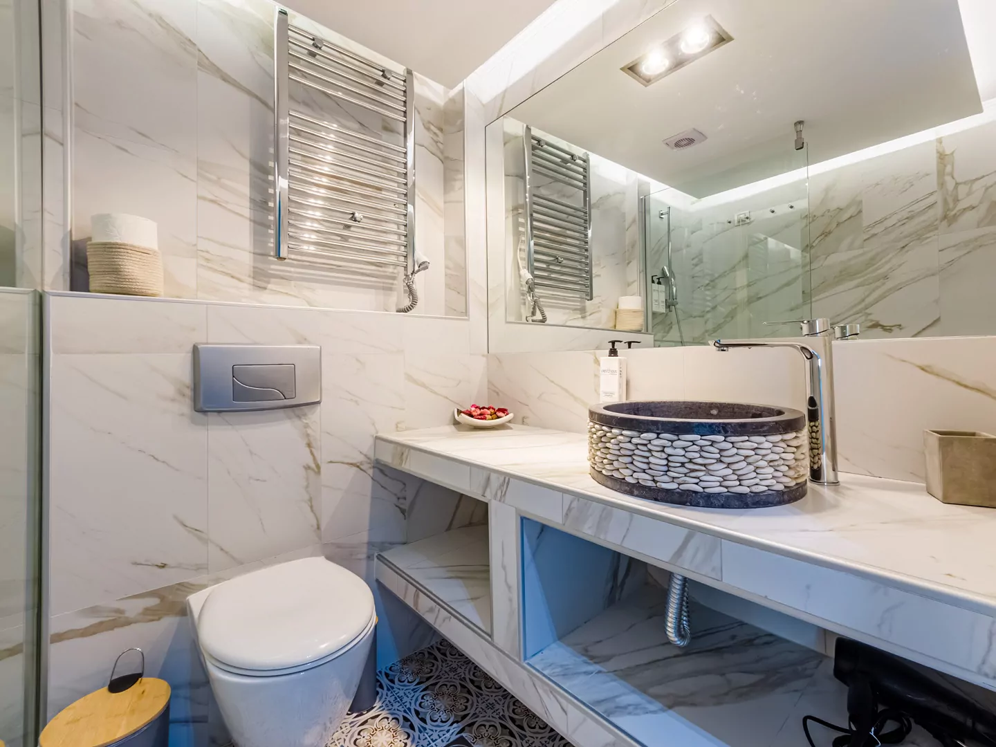 Modern marble bathroom with walk-in rain shower and luxury amenities at Alpha Luxury Suites