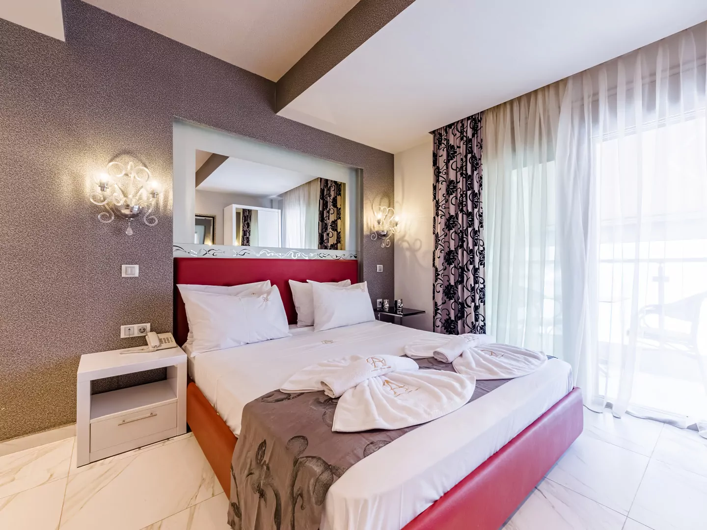 Modern luxury suite bedroom with sea view balcony at Alpha Luxury Suites Pefkohori Halkidiki