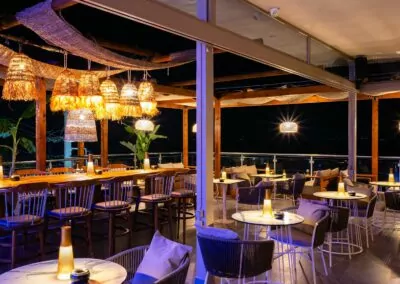 Sunset view from Alpha Luxury Suites Rooftop Bar in Pefkohori with sea view and cocktails