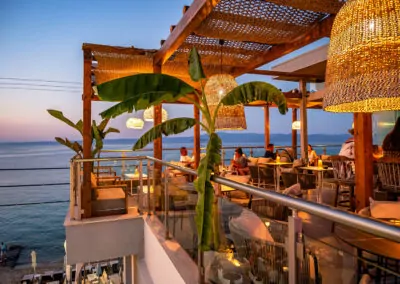 Sunset view from Alpha Luxury Suites Rooftop Bar in Pefkohori with sea view and cocktails
