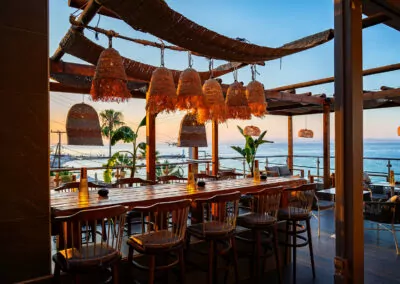 Sunset view from Alpha Luxury Suites Rooftop Bar in Pefkohori with sea view and cocktails