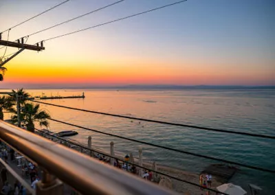 Sunset view from Alpha Luxury Suites Rooftop Bar in Pefkohori with sea view and cocktails