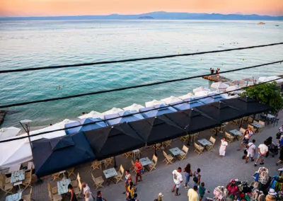 Sunset view from Alpha Luxury Suites Rooftop Bar in Pefkohori with sea view and cocktails