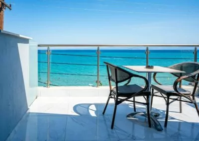 Sunset view from Alpha Luxury Suites Rooftop Bar in Pefkohori with sea view and cocktails