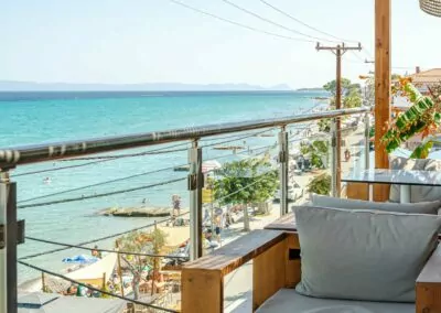 Sunset view from Alpha Luxury Suites Rooftop Bar in Pefkohori with sea view and cocktails